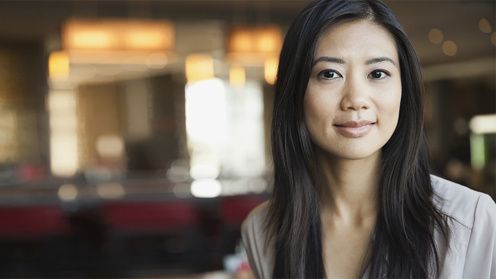 woman smiling at the camera with a blurred background