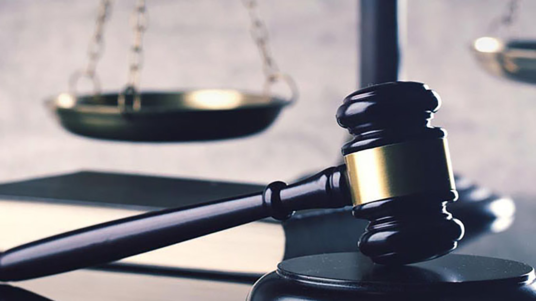 Closeup view of a gavel resting against a wooden block