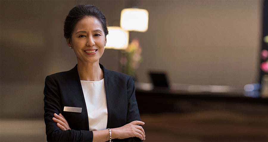 Hotel manager posing for the camera with arms crossed