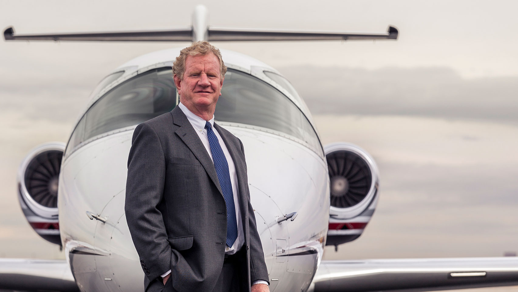 Will Cutter, Cutter Aviation CEO posing in front of a plane