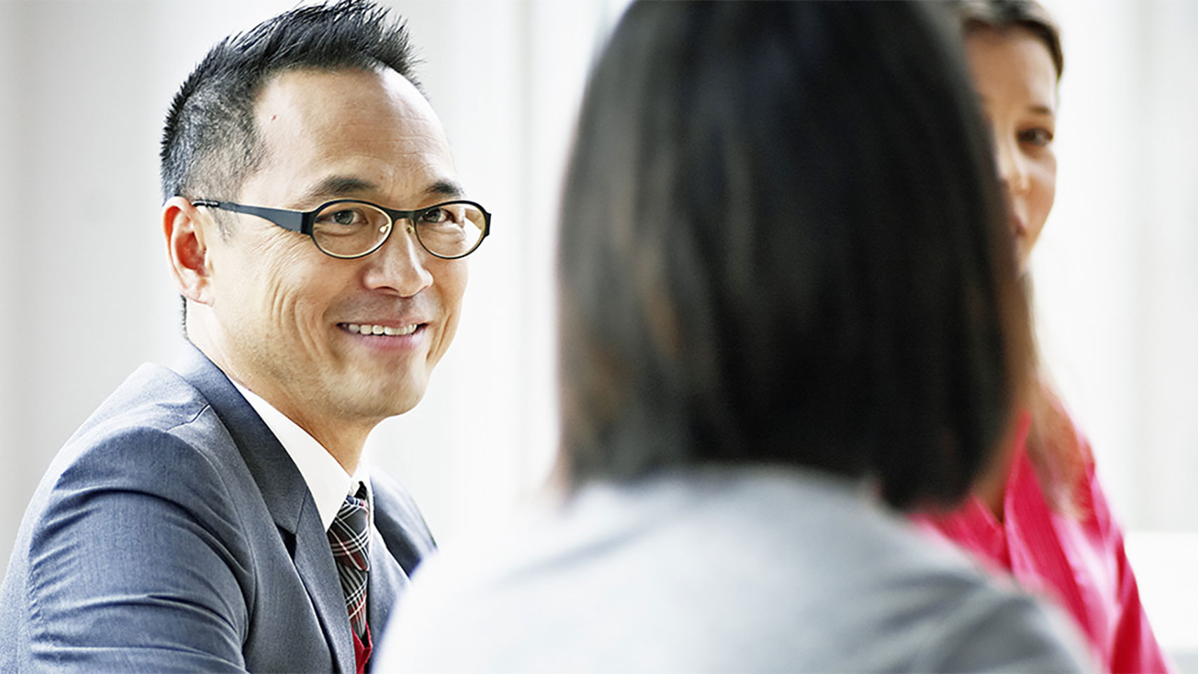 Businessman smiling at a peer