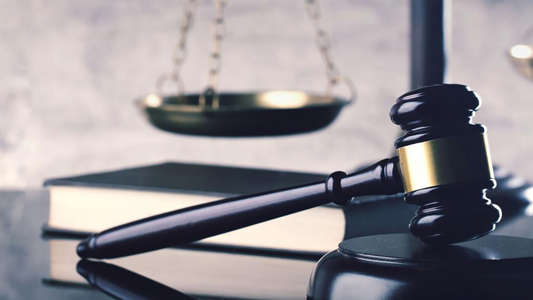 Closeup view of a gavel resting on a wooden block