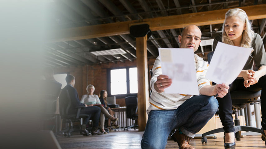 Two people looking at shared documents