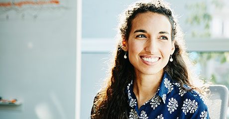 Smiling businesswoman listening to presentation during meeting in conference room