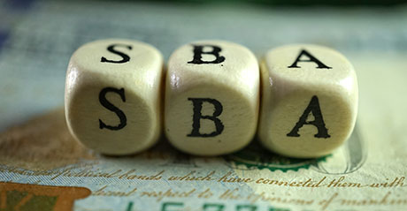 wooden dice spelling out S-B-A