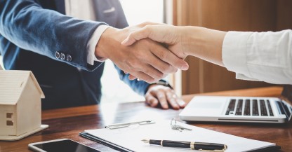 Close up of man and woman shaking hands.