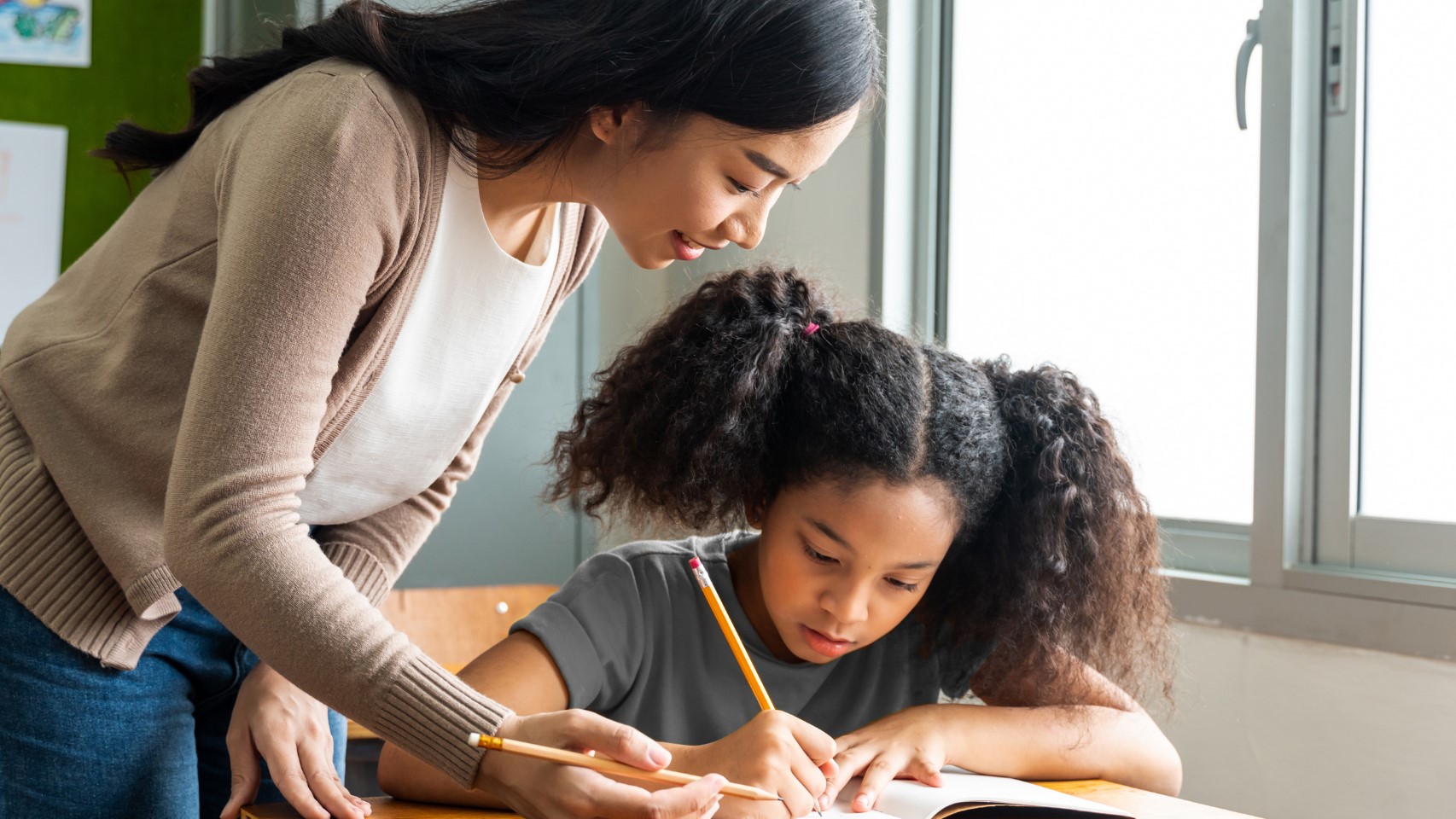 Woman helping a child with her school work