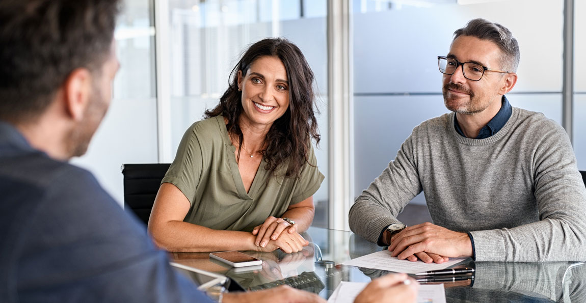 A fiduciary banker sitting at a table with clients