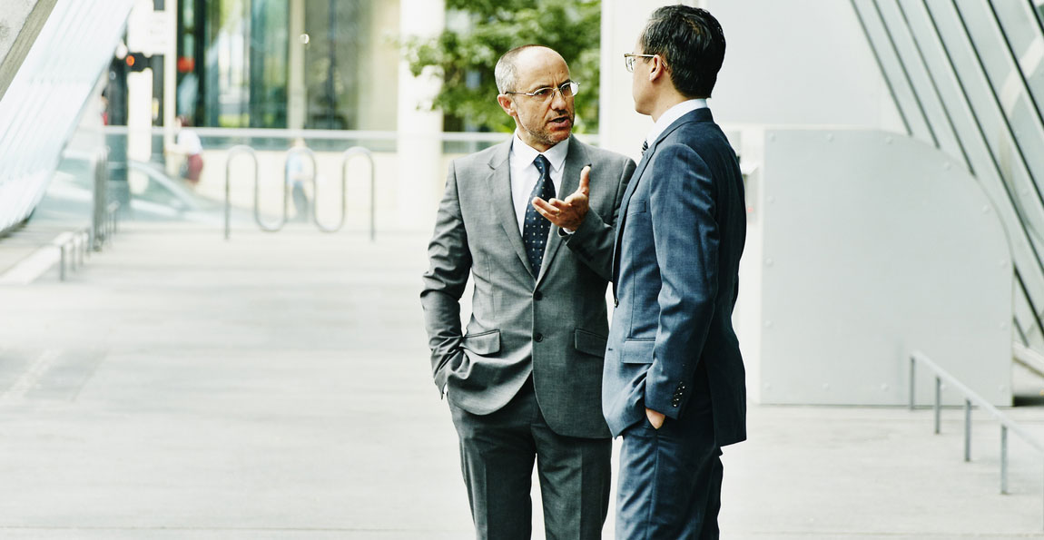 Two financiers having a conversation outside