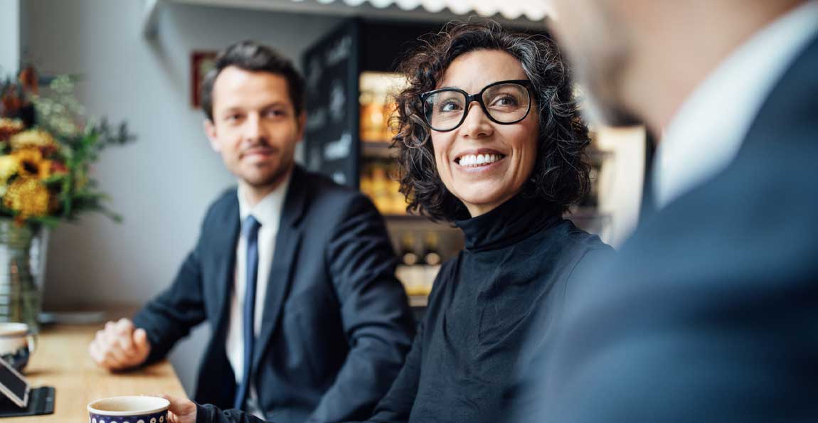 A businesswoman smiling during a meeting with her bankers