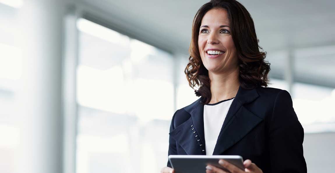 A woman viewing investment information on a tablet device