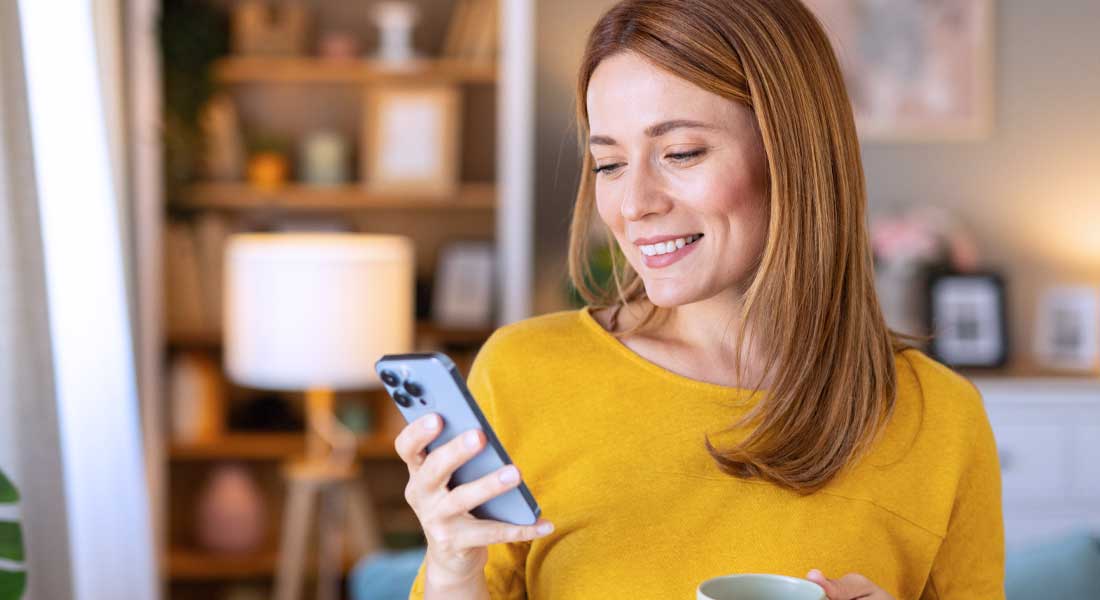 A young woman using a banking app on her mobile phone