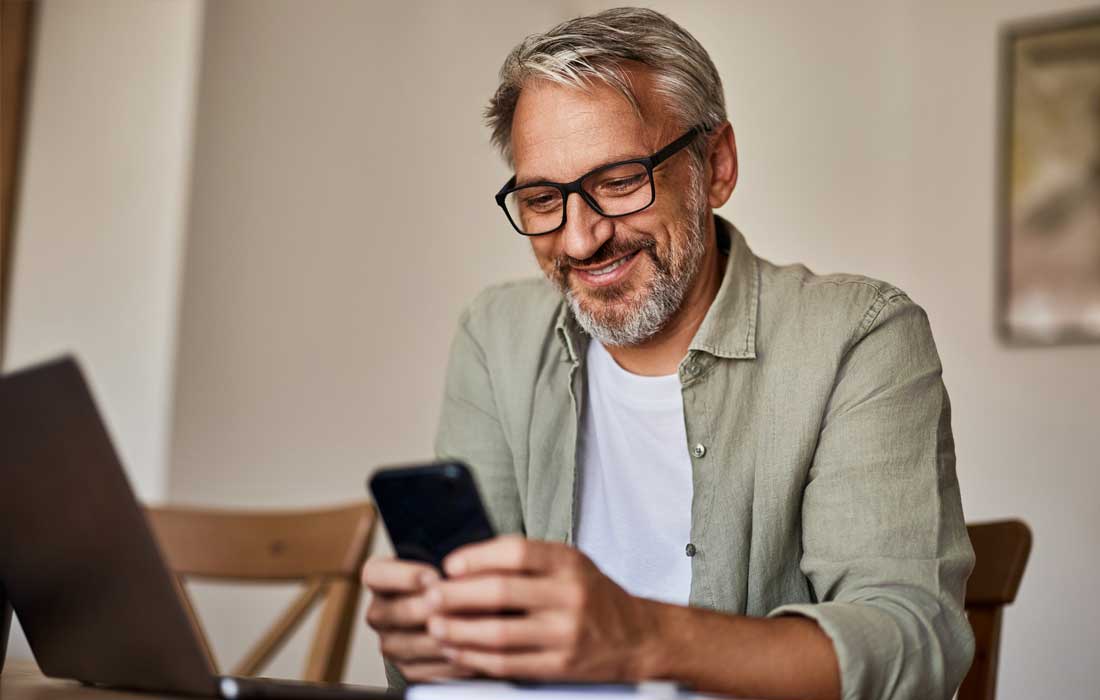 A man completing bank transaction on a mobile app