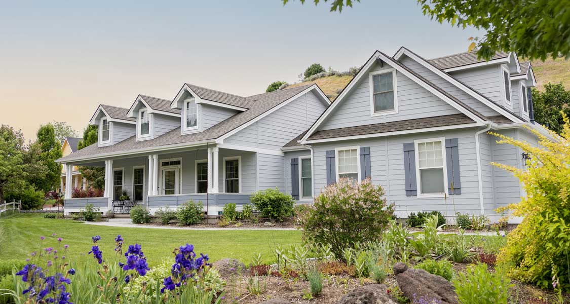 A bright white house on a suburban street