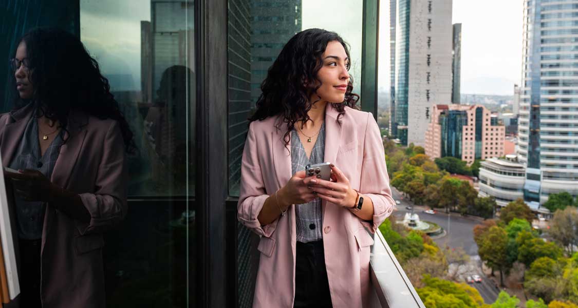 A young woman completing banking transactions on her mobile phone