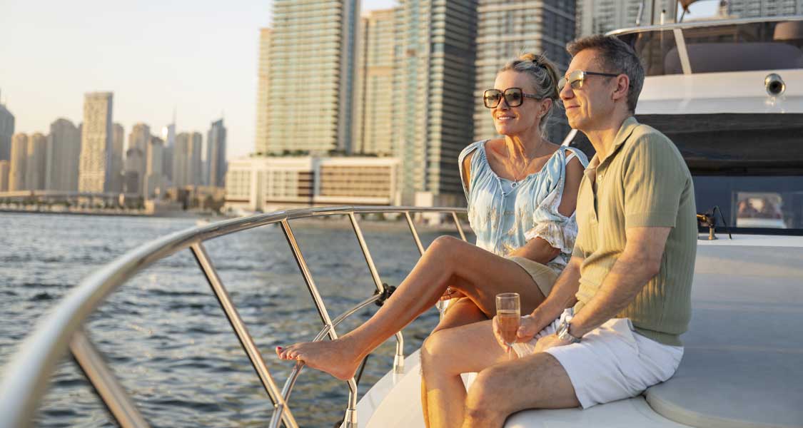 A married couple sitting on a yacht at sunset