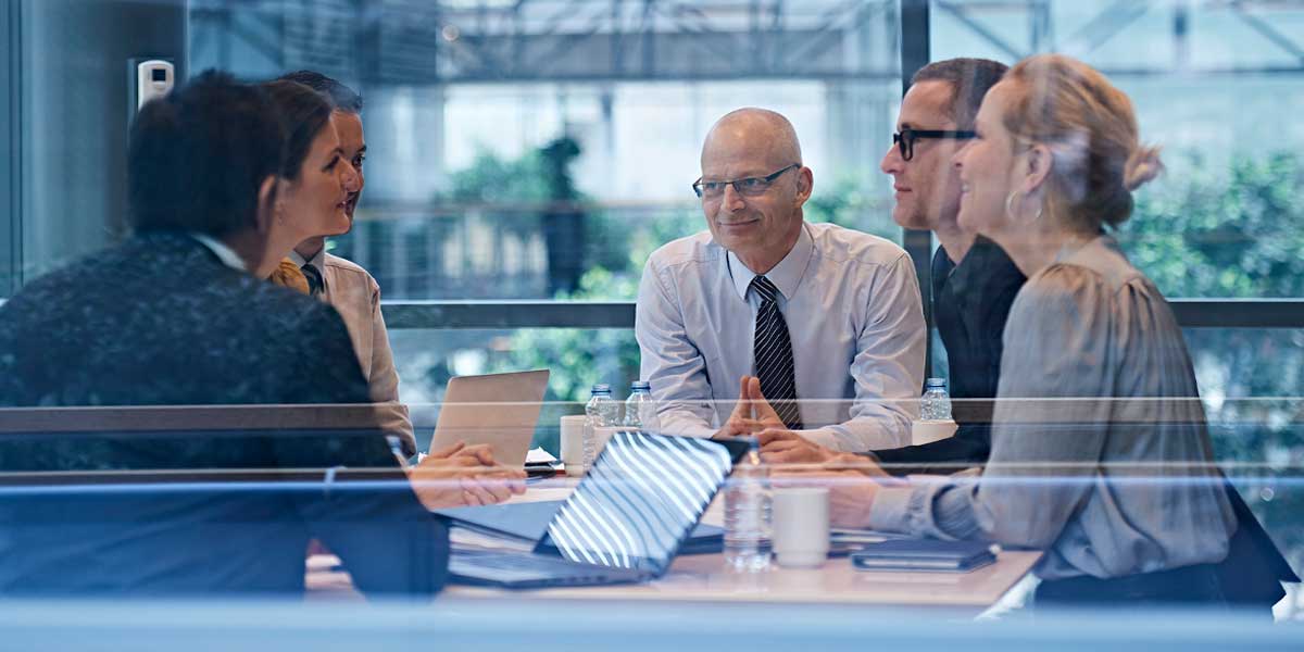 Escrow banking specialists in a bright meeting room