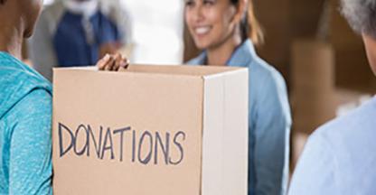 Woman holding a cardboard box for donations