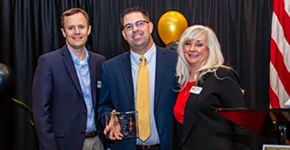 Three Bank of Nevada employees posing with an award