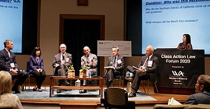 people sitting in a panel on a stage