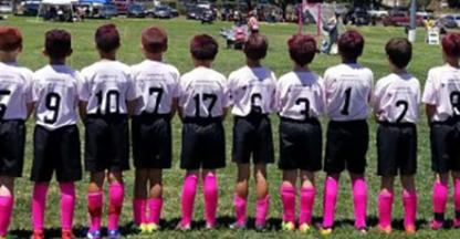 young soccer players standing on the field