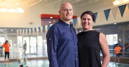 Aqua Tech owners posing for the camera by an indoor pool