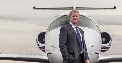 Will Cutter, Cutter Aviation CEO posing in front of a plane