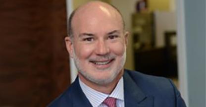 Dennis Abbott, FirstService Residential President, smiling at the camera