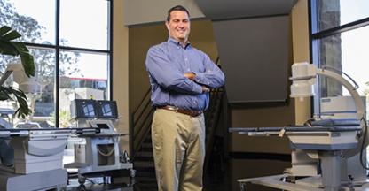 Chris Gleason, NextMed CEO, posing in a surgery suite