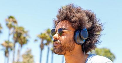 Man wearing sunglasses & headphones