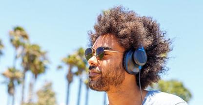 Man wearing sunglasses & headphones