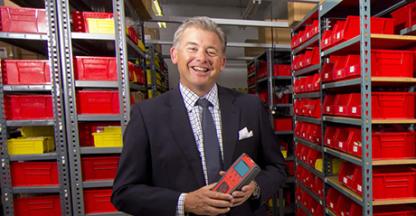 Brad Mountz, Chief Executive Officer, posing in the warehouse and smiling at the camera