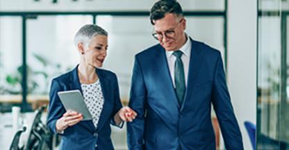 Business man and business woman talking in an office