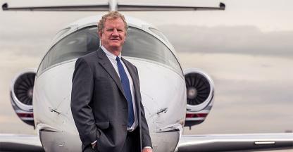 Will Cutter, Cutter Aviation CEO posing in front of a plane