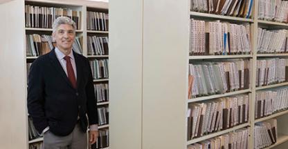 Man posing in a legal documents file room