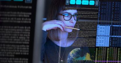 Woman looking at data on computer screen