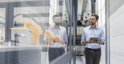 Man holding tablet in a factory