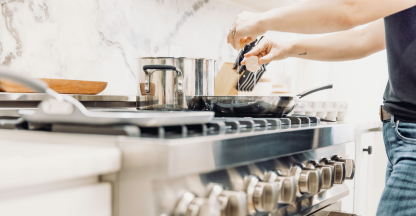 Photo of a person cooking on a stove