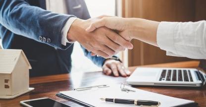 Close up of man and woman shaking hands.