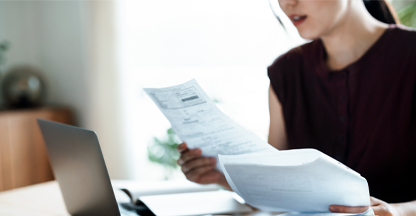 Woman looking at paper documents