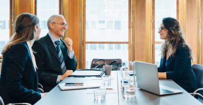 Two business owners discussing succession planning with a corporate lawyer