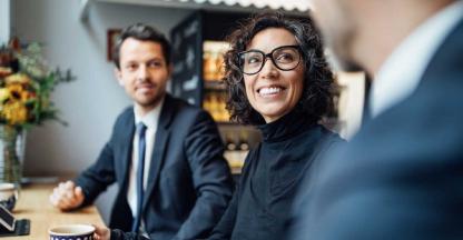 A businesswoman smiling during a meeting with her bankers