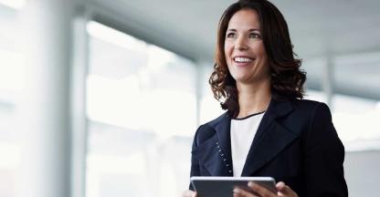 A woman viewing investment information on a tablet device