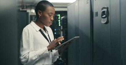 An IT professional working in a server room