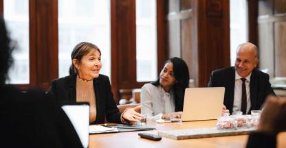 A legal team discussing a mass arbitration in an elegant meeting room