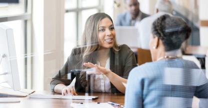 A banker discussing banking options with their client.