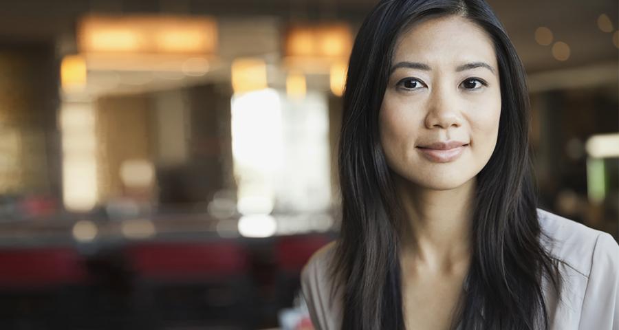 woman smiling at the camera with a blurred background