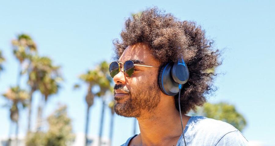 Man listening to headphones and wearing sunglasses