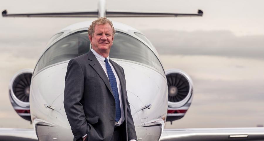 Will Cutter, Cutter Aviation CEO posing in front of a plane