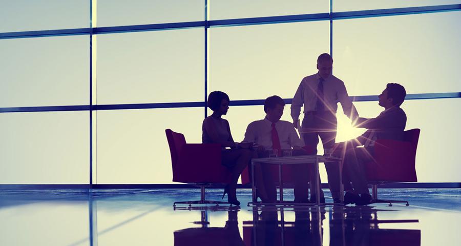 A group of colleagues meeting in an open meeting space